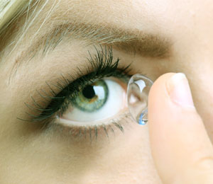 close up of contact lens being inserted into eye
